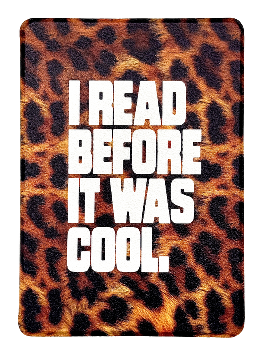 Photo of the front of a kindle that says "I read before it was cool" on a leopard print background