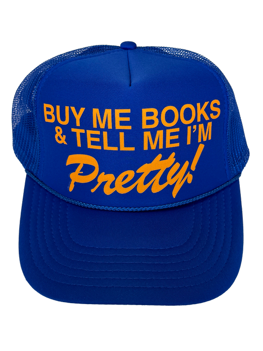 Blue Trucker hat that says in golden text "Buy me books and tell me I'm pretty!"